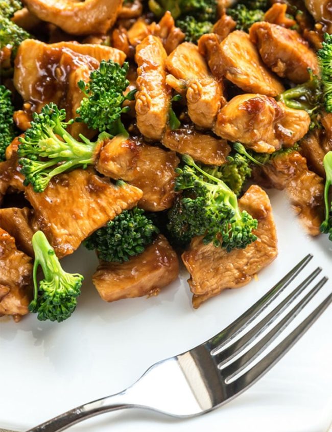 The plated Chinese Chicken & Broccoli ready to eat with a fork next to it