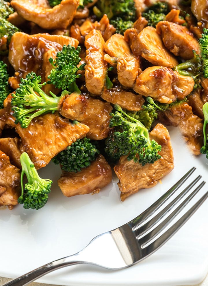 The plated Chinese Chicken & Broccoli ready to eat with a fork next to it