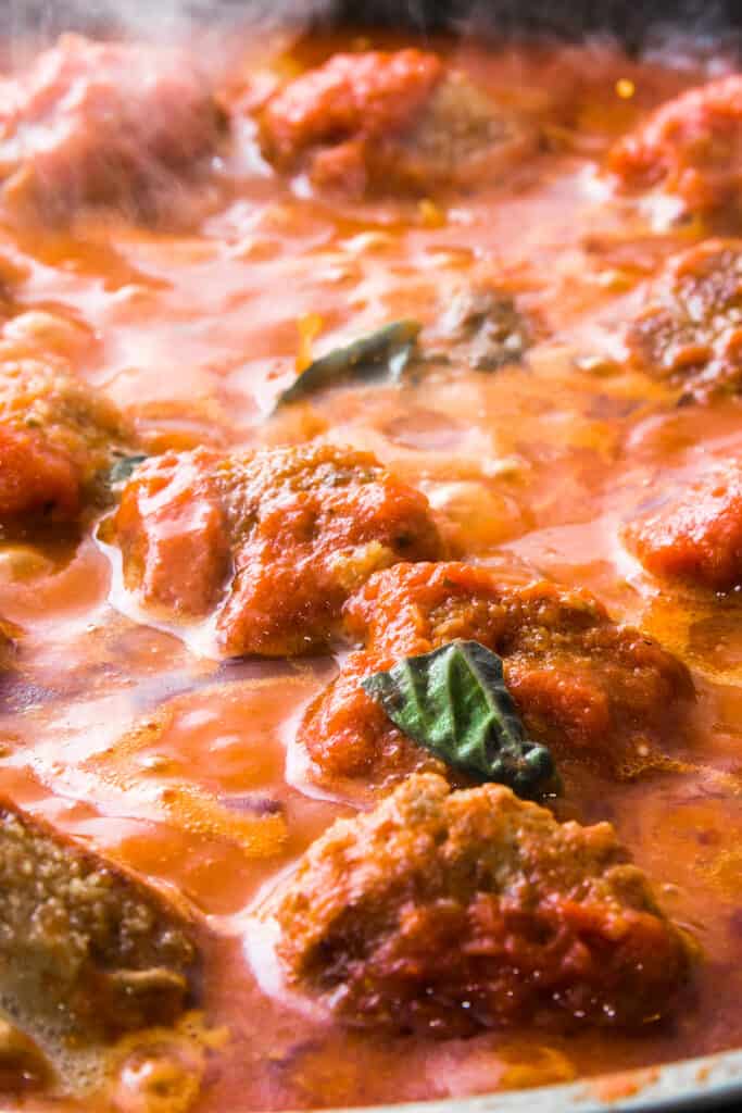 sausage meatballs cooking in tomato sauce