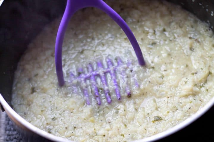 Cauliflower being mashed in a pot