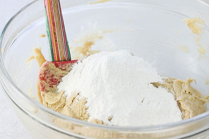 The flour mixture being added to the bowl