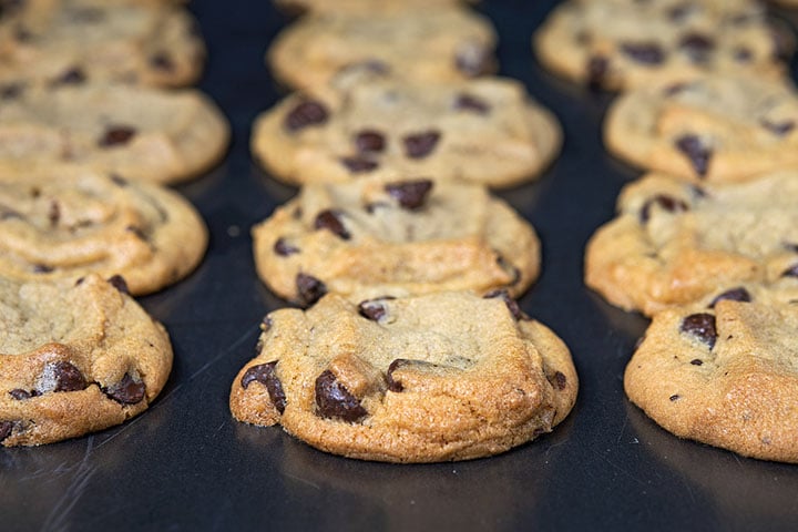 close up of homemade chocolate chip cookies on cookie sheet