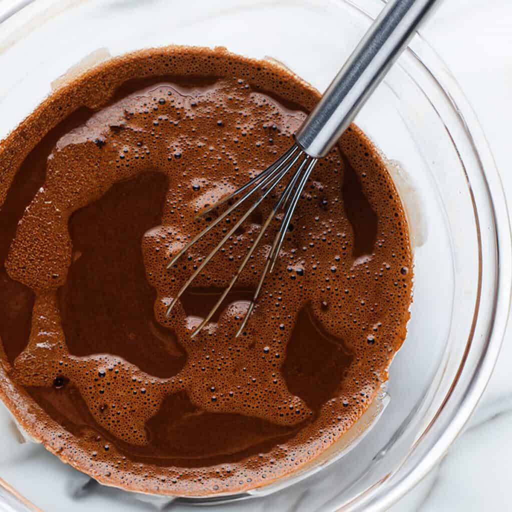 The coffee, cocoa powder, and water mixed in a glass bowl.