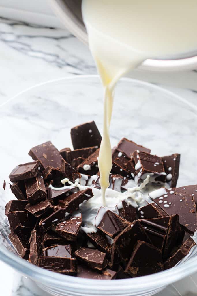 pouring the hot cream over the chopped chocolate.