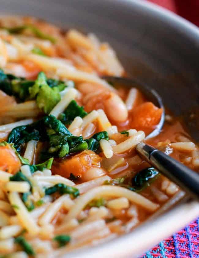 A close up of Ribollita soup with lots of pasta