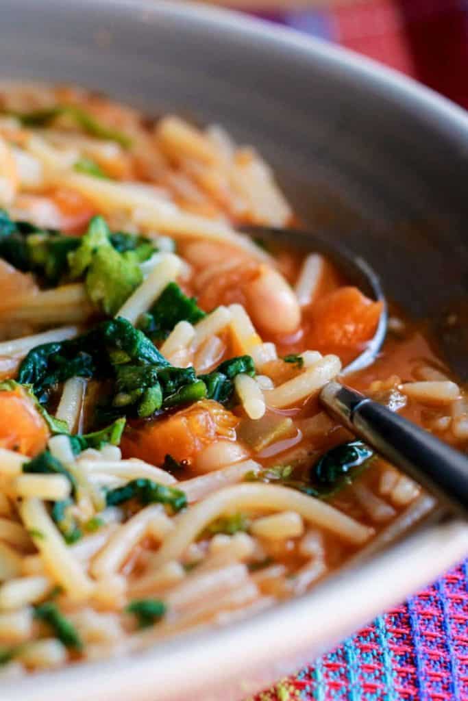 A close up of Ribollita soup with lots of pasta