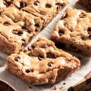 a batch of fresh cut chocolate chip blondies on baking paper