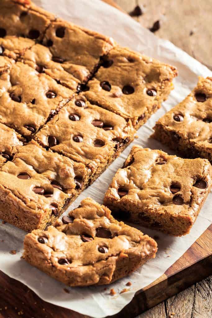 a batch of fresh cut chocolate chip blondies on baking paper