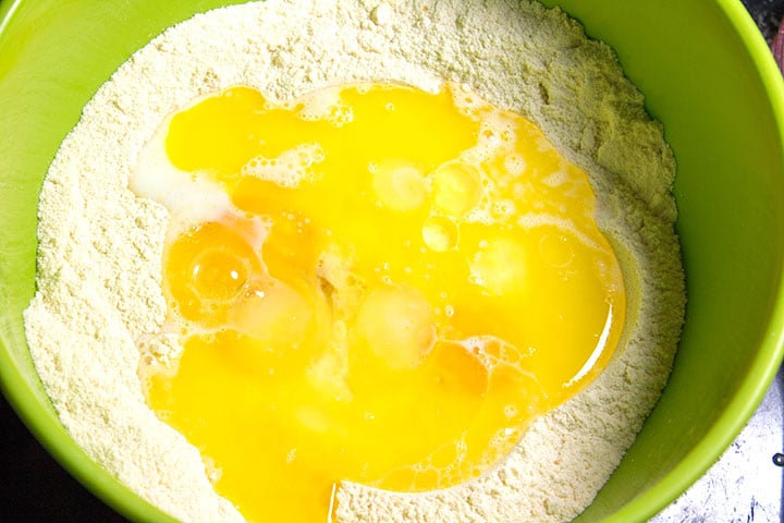 The eggs, milk, butter and oil added to the dry ingredients in a bowl