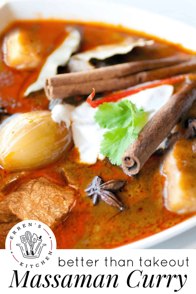 A bowl of massaman curry with potatoes, onions, lamb, coconut cream, cinnamon sticks and cilantro leaves.