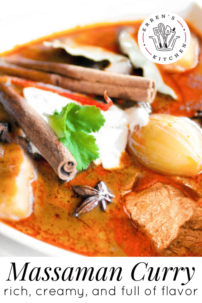 A bowl of massaman curry with potatoes, onions, lamb, coconut cream, cinnamon sticks and cilantro leaves.