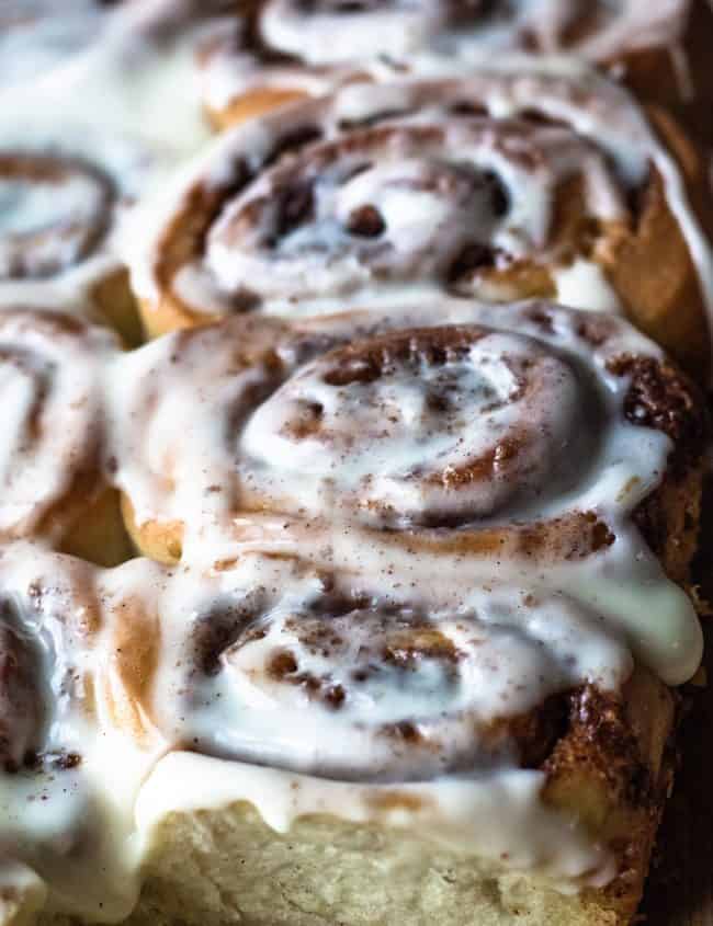 A buatch of frosted cinnamon rolls ready to eat