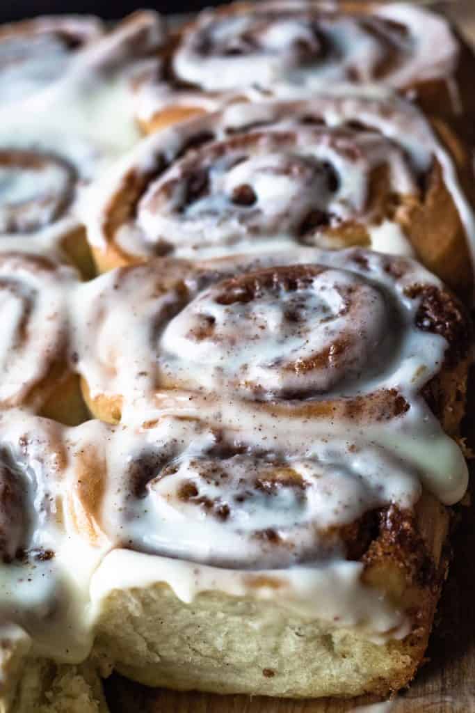 A buatch of frosted cinnamon rolls ready to eat