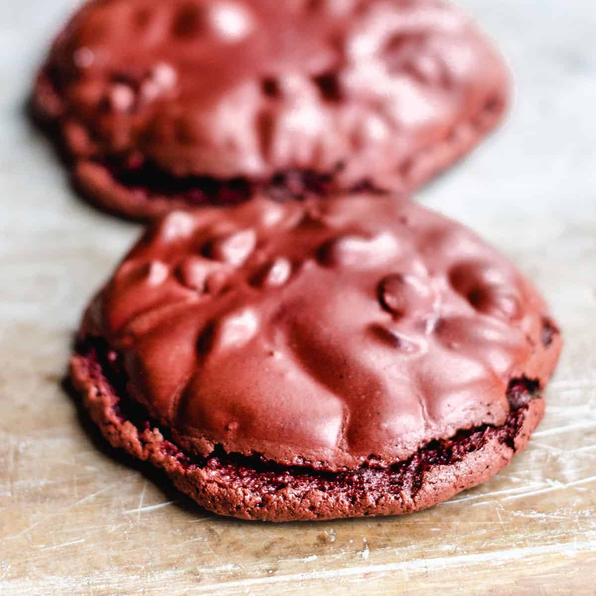 wo red velvet cookies lines up on a tray