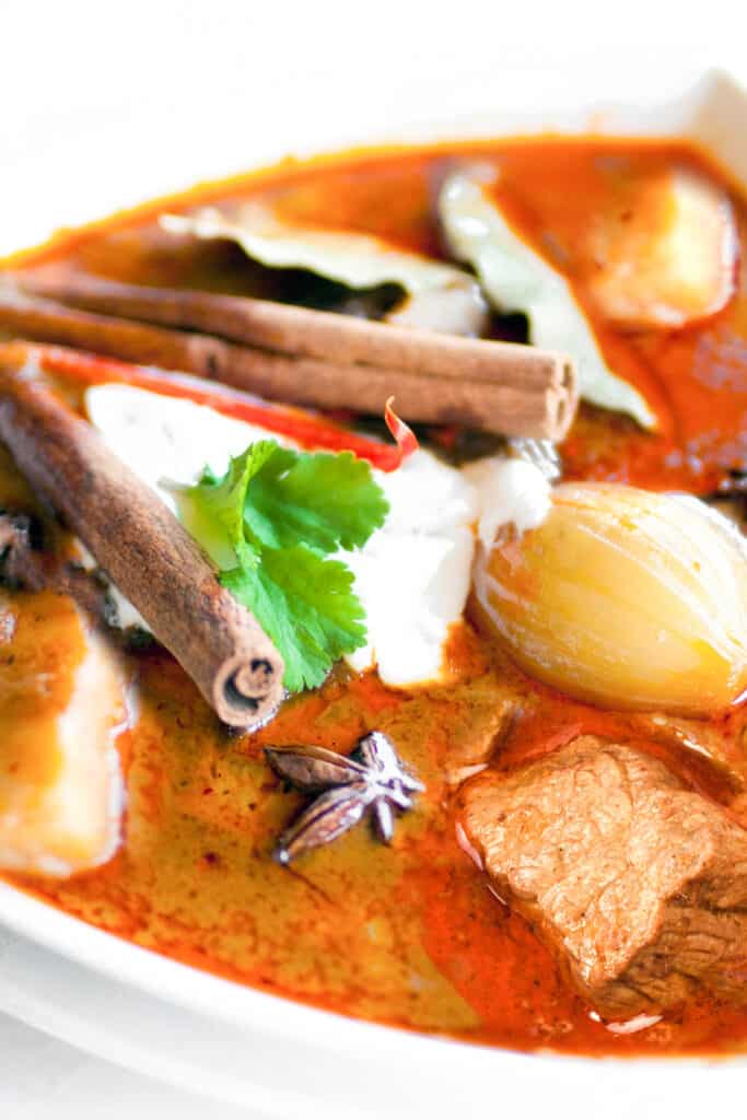 a bowl of Massaman Curry with lamb, potatoes and onions