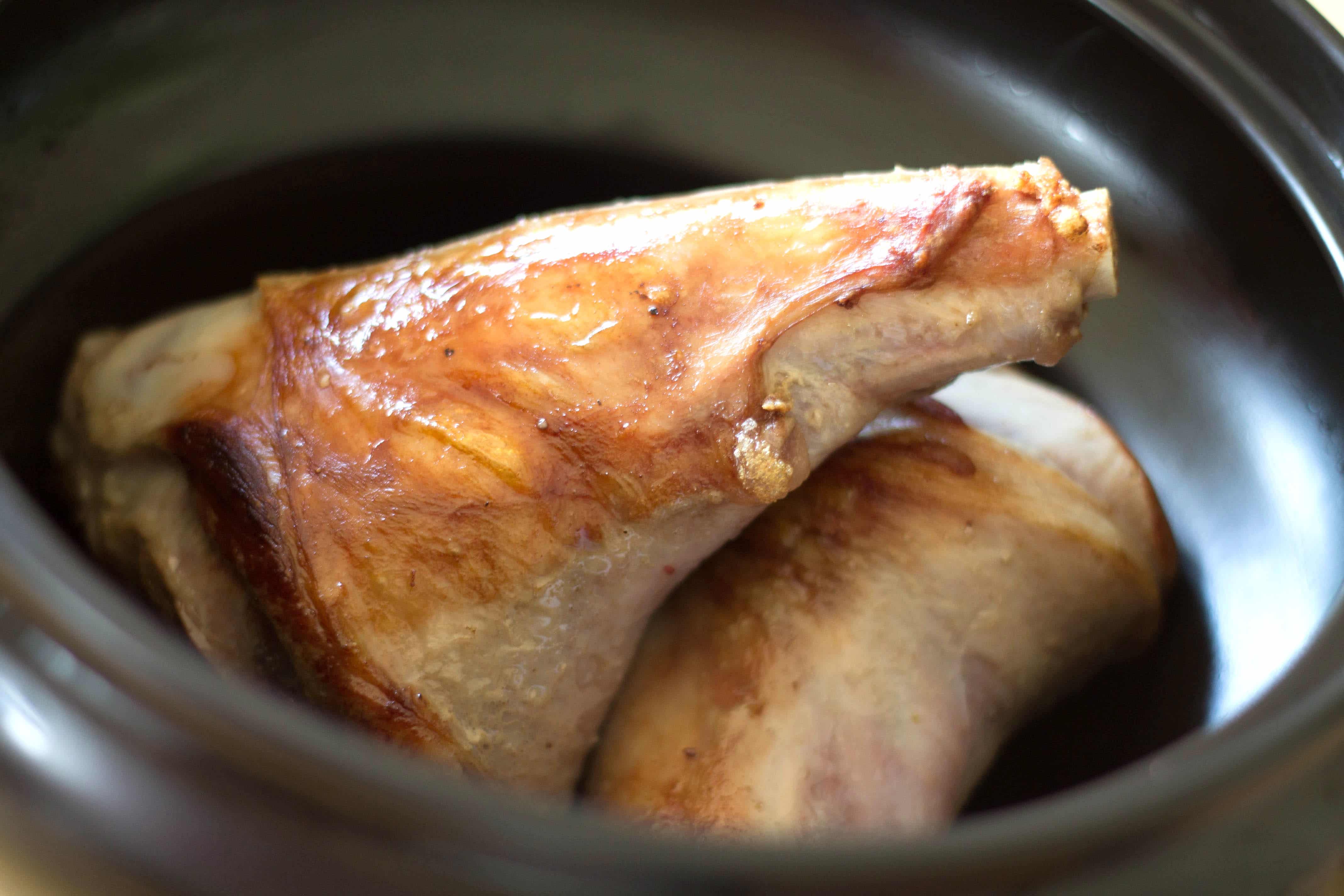 Lamb Shanks in a pan, browned.