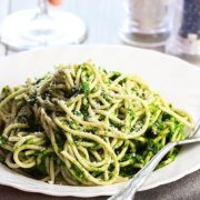 A bowl of Spaghetti with Spinach Sauce with a fork next to it on the plate