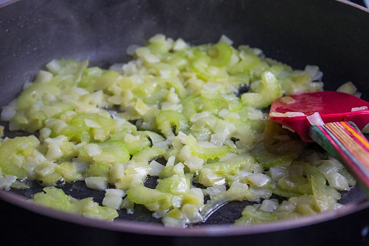Onions and celery cooking in butter in a frying pan