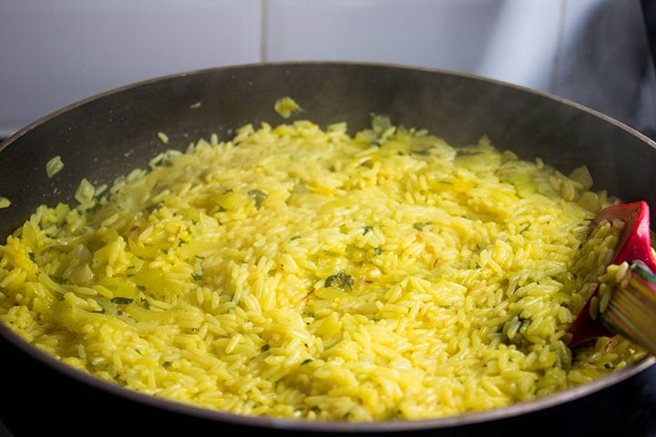 The rice fully cooked in the pan
