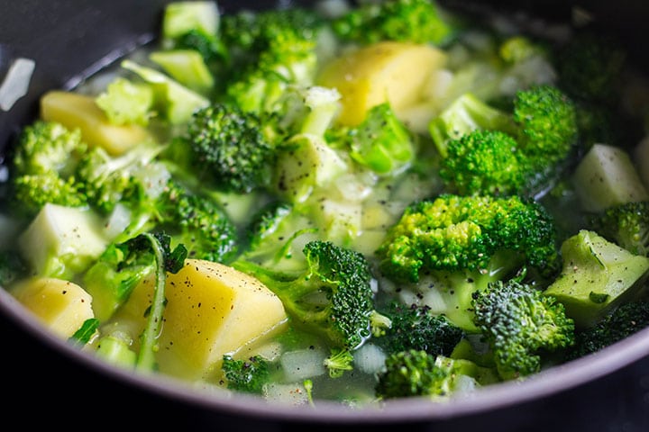 The broccoli, potatoes and seasoning added to the soup 