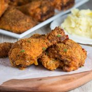 Three pieces of Easy Oven Fried Chicken speckled with parsley