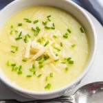 potato leek soup topped with chopped chives and grated cheddar