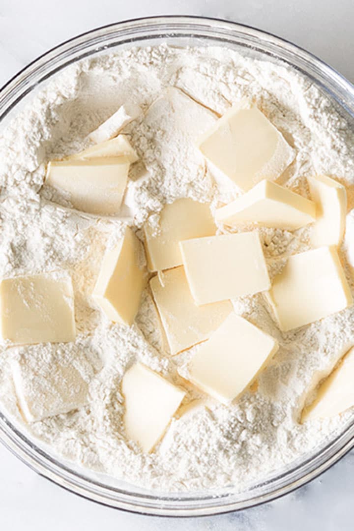 Butter in a glass bowl with the flour mixture