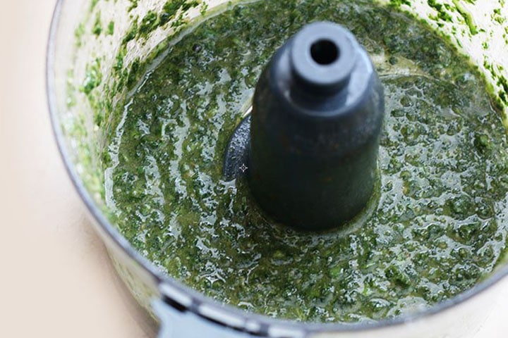 The spinach pureed in a food processor.