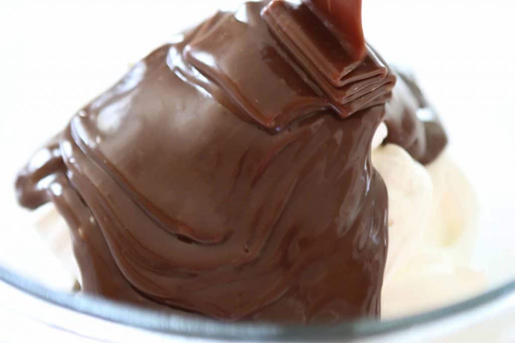 melted chocolate being added to the cream cheese mixture