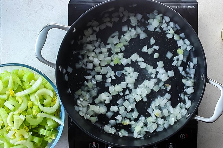 Onions being cooked in a pan