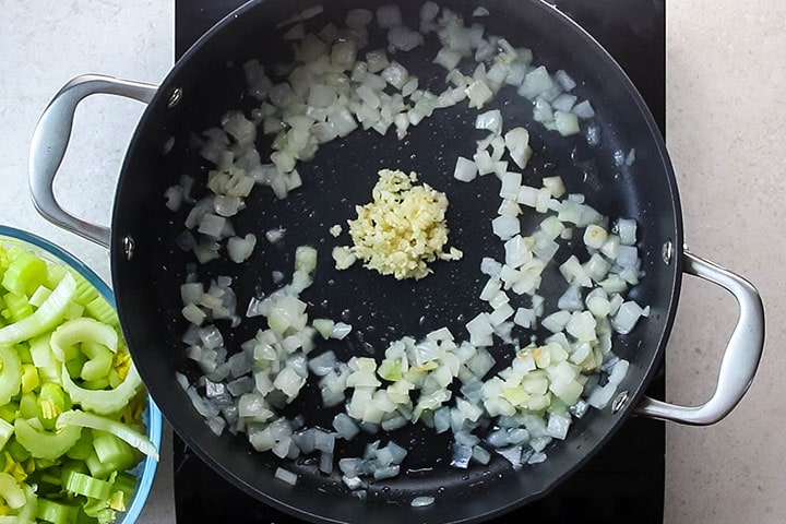 Onions and garlic being cooked in a pan