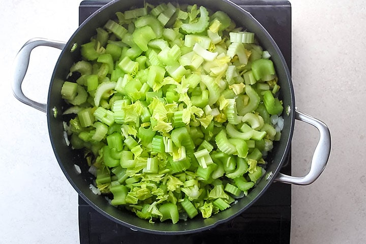 Celery added to the pan with the onions and garlic