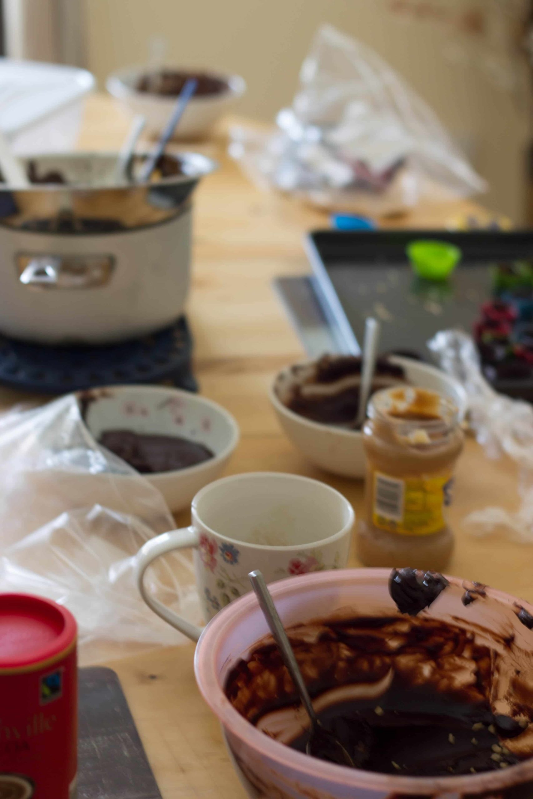mess in the kitchen, bowls covered in chocolate, unopened jars and dirty pans.