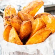 a metal basket filled with crispy, golden Potato Wedges