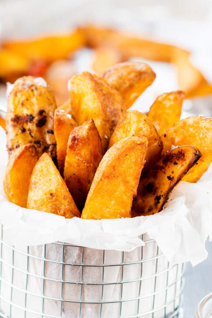 a basket filled with golden Potato Wedges