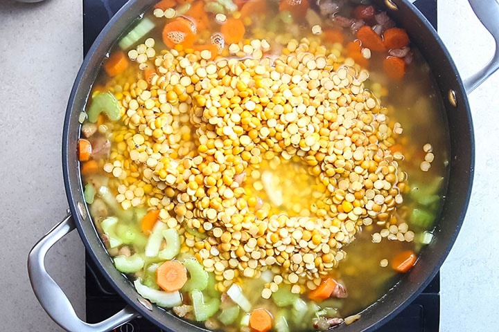 the peas and stock added to the pan