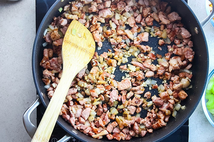 Onions and garlic cooking with the bacon