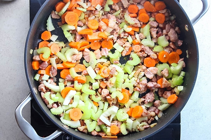carrots and celery added to the pan