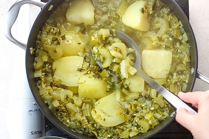 The celery being scooped from the pot 