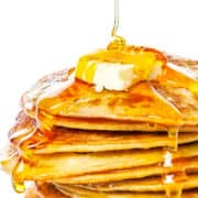 a pile of johnny cakes with butter and syrup