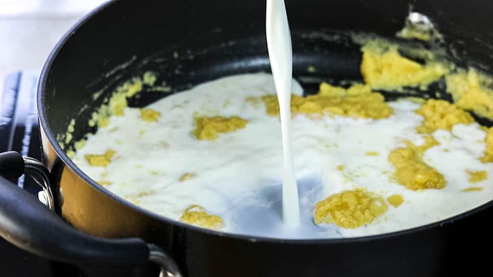 The milk being poured into the pan