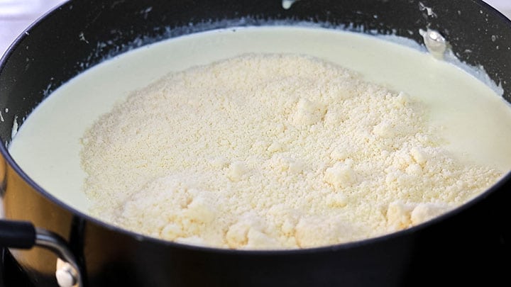 The Parmesan cheese added to the milk mixture