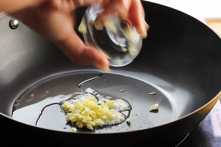 The garlic added to the oil in the wok