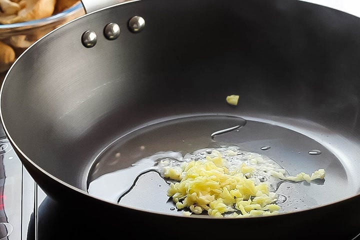 The ginger added to the garlic added to the oil in the wok