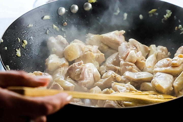 The chicken browning in the wok