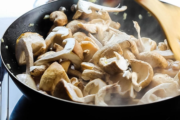 The fresh mushrooms added to the wok with the chicken, garlic and ginger