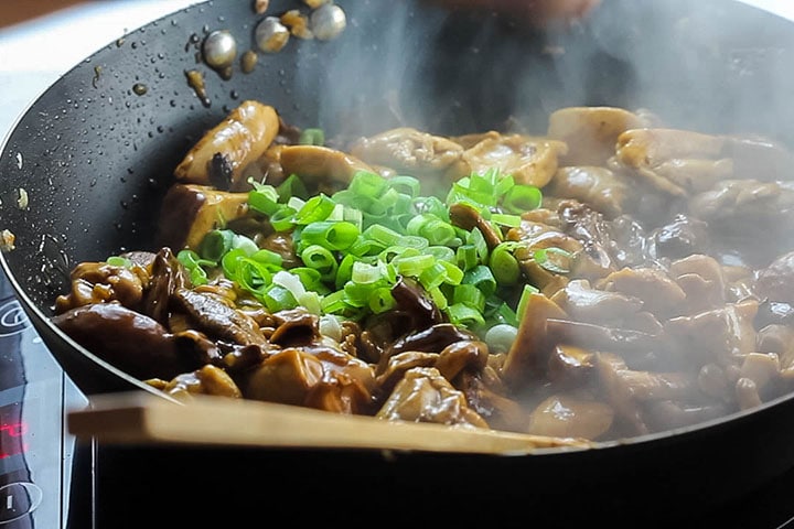 The green onions added to the wok with the Chicken and Chinese Mushrooms