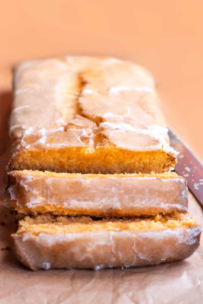 a tangerine loaf cake with drizzle icing sliced