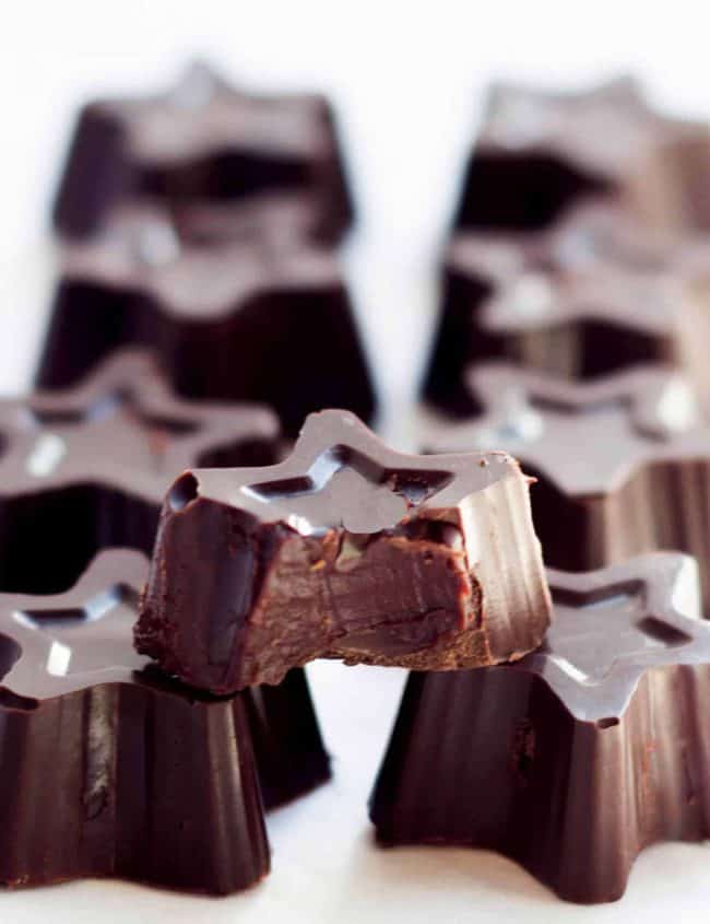 Dark Chocolate Truffles lined up next to each other with one showing the filling