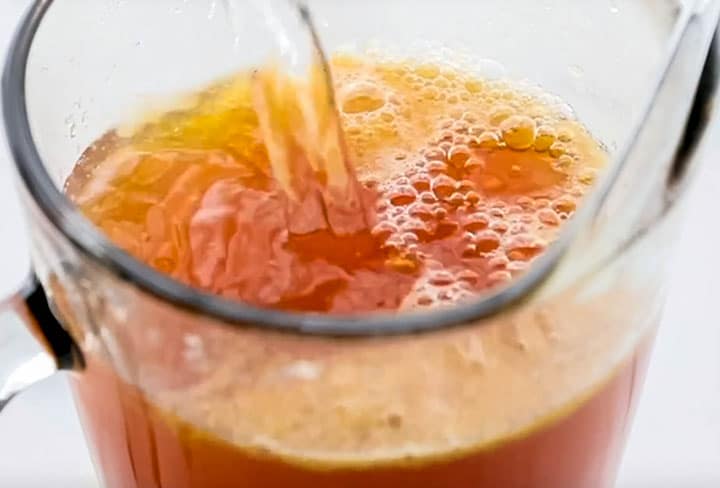 water being added to the peach tea mixture